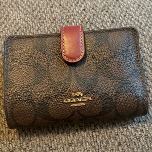 Used Coach medium corner zip wallet